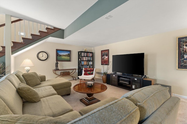 carpeted living area featuring stairs and baseboards