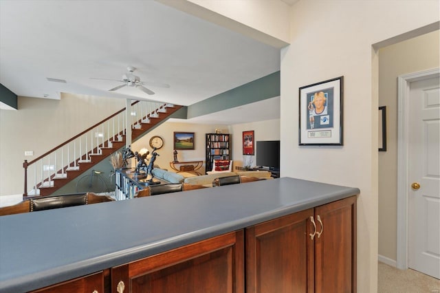 bar featuring stairs, visible vents, light carpet, and a ceiling fan