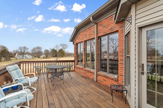 wooden terrace featuring outdoor dining area