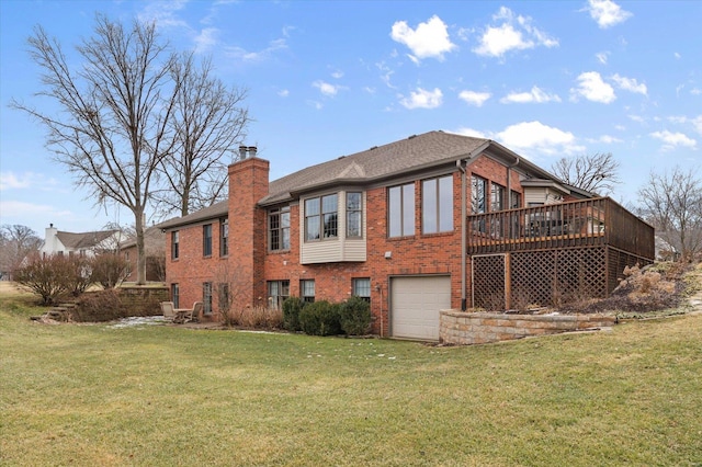 rear view of house featuring brick siding, a yard, a chimney, an attached garage, and a deck