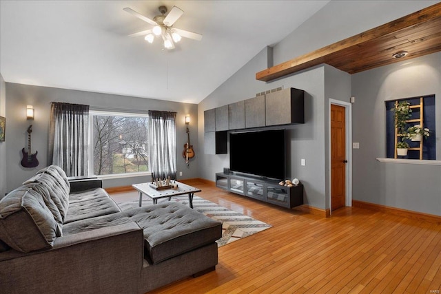 living room with high vaulted ceiling, ceiling fan, and light hardwood / wood-style flooring