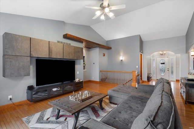 living room featuring light hardwood / wood-style flooring, ceiling fan, and vaulted ceiling