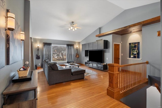 living room with vaulted ceiling, ceiling fan, and light wood-type flooring