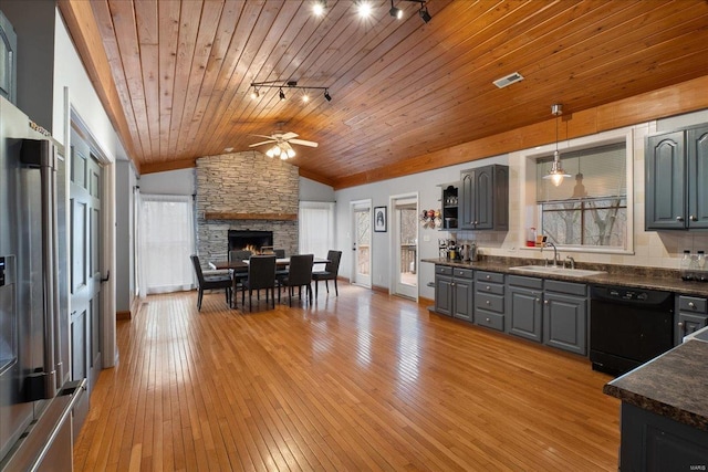 kitchen with high end fridge, sink, gray cabinetry, hanging light fixtures, and black dishwasher