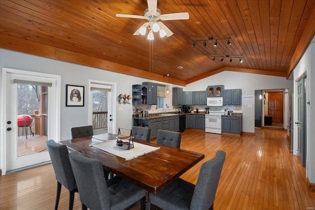 dining room with vaulted ceiling, sink, wood ceiling, track lighting, and light hardwood / wood-style flooring