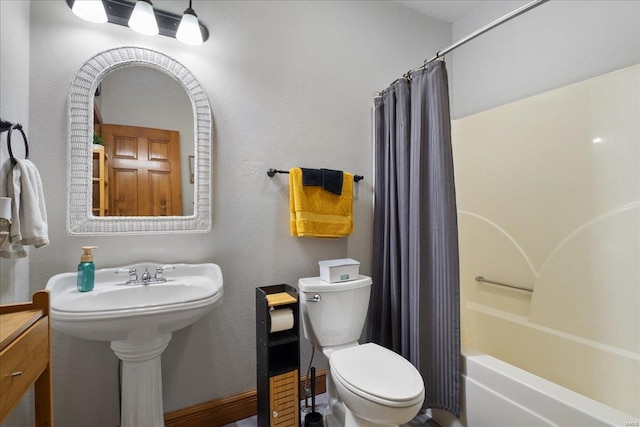 bathroom with shower / tub combo and toilet