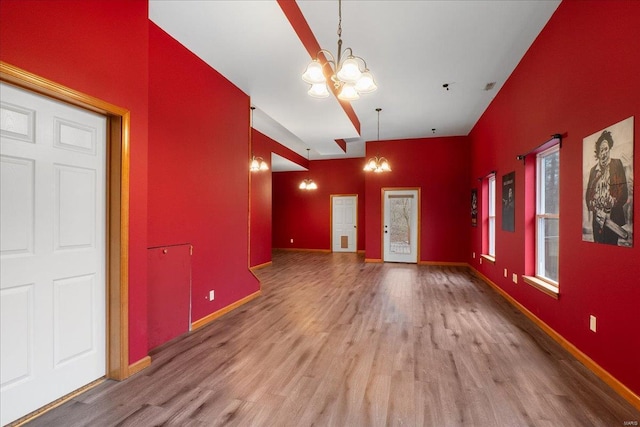 interior space featuring wood-type flooring and an inviting chandelier