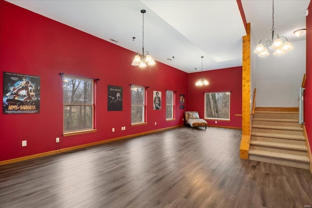 interior space with dark hardwood / wood-style flooring, high vaulted ceiling, and an inviting chandelier