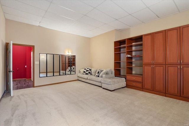 unfurnished room featuring light carpet and a drop ceiling