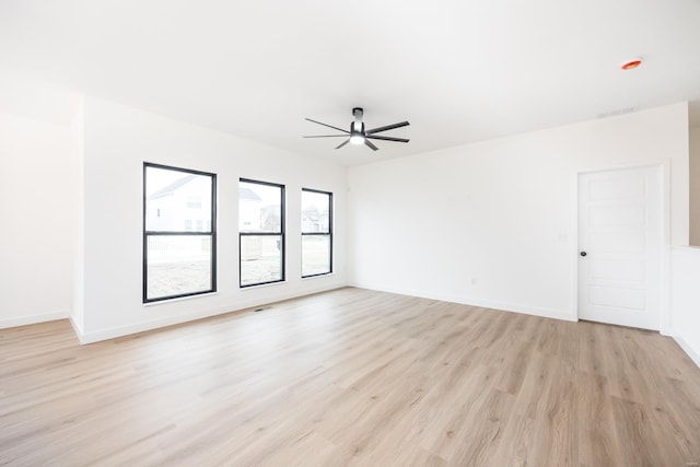 unfurnished room with ceiling fan and light hardwood / wood-style floors