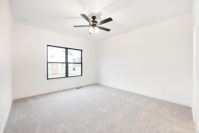 unfurnished room featuring light carpet and ceiling fan