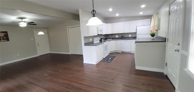 kitchen featuring pendant lighting, dark countertops, dark wood-type flooring, white cabinetry, and white appliances