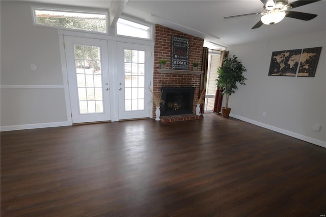 unfurnished living room with baseboards, dark wood-style floors, ceiling fan, vaulted ceiling with beams, and a fireplace