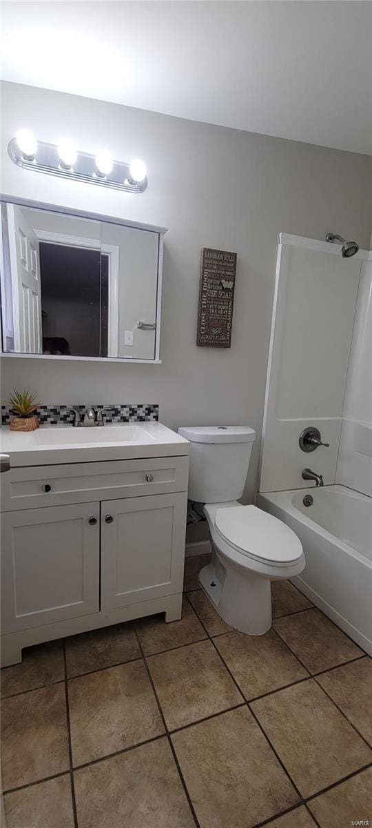 full bathroom featuring shower / washtub combination, tile patterned flooring, vanity, and toilet