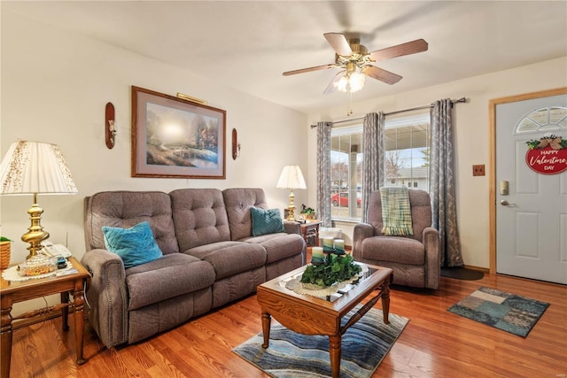 living room with ceiling fan and wood-type flooring