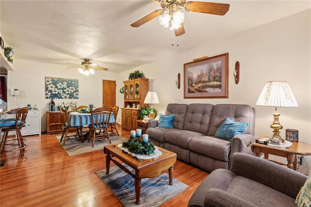 living room featuring hardwood / wood-style floors and ceiling fan