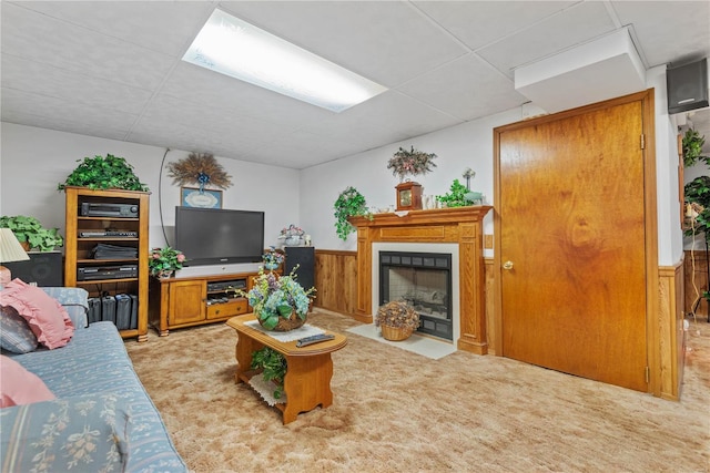 living room with light colored carpet and a drop ceiling