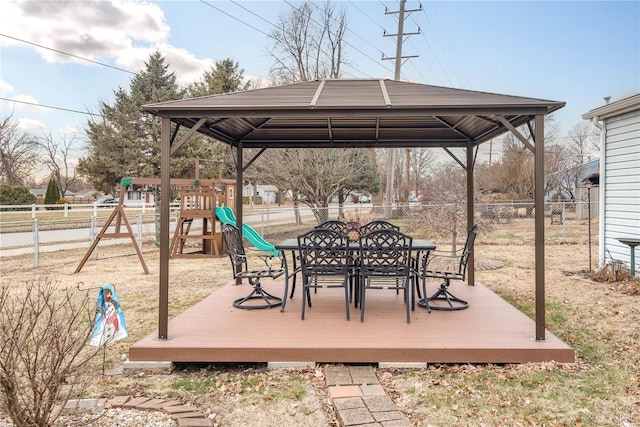 wooden deck featuring a playground and a gazebo