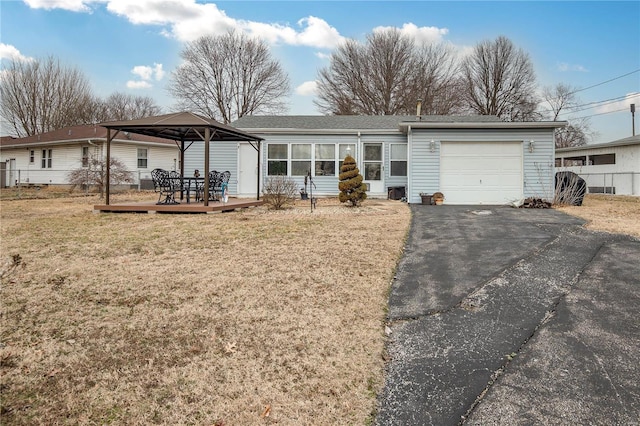 single story home with a garage, a gazebo, and a front yard