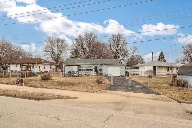 view of front of house with a garage and a playground