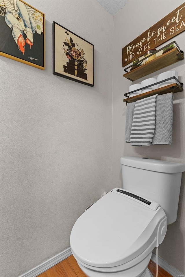 bathroom with wood-type flooring and toilet