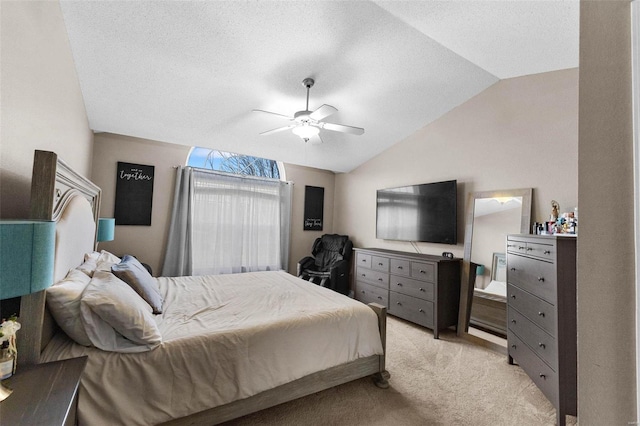 carpeted bedroom featuring ceiling fan, lofted ceiling, and a textured ceiling