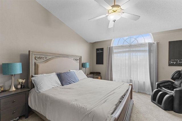 carpeted bedroom featuring ceiling fan, lofted ceiling, and a textured ceiling