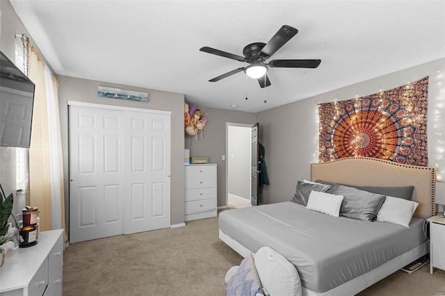 bedroom featuring light carpet, a closet, and ceiling fan