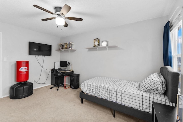 carpeted bedroom with ceiling fan and a textured ceiling