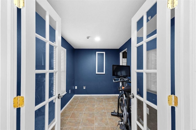 exercise area with tile patterned flooring and french doors