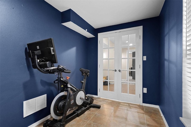 workout area featuring french doors and light tile patterned flooring