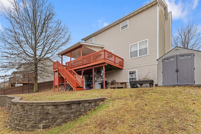 back of property with a deck, a lawn, and a storage unit