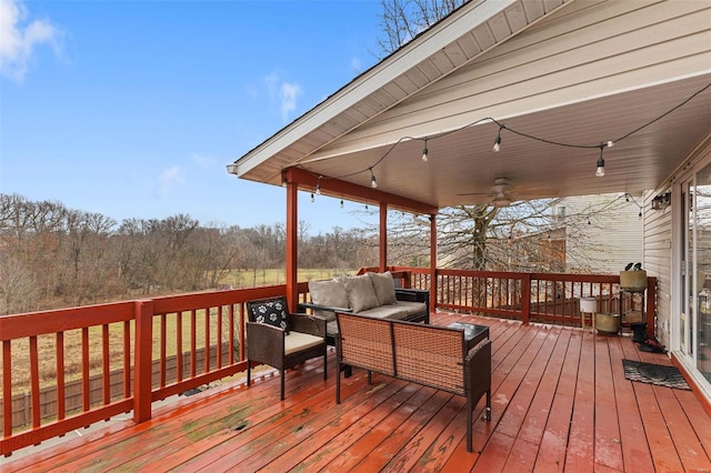 deck with an outdoor living space and ceiling fan