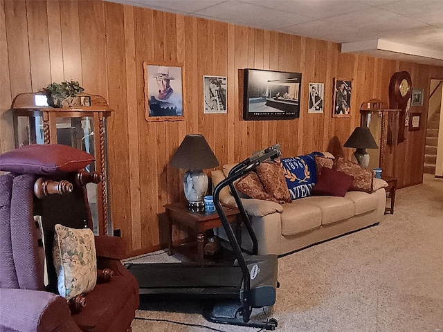 living room featuring carpet floors and wood walls