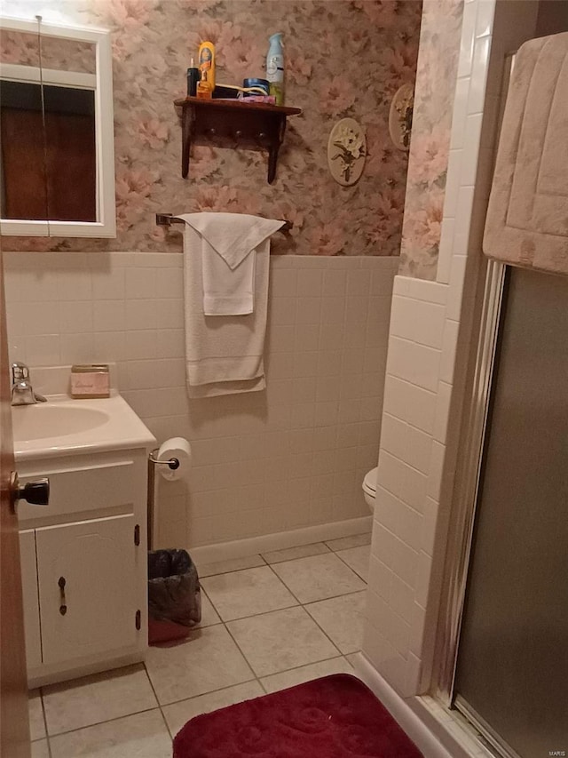 bathroom featuring vanity, toilet, an enclosed shower, and tile patterned flooring