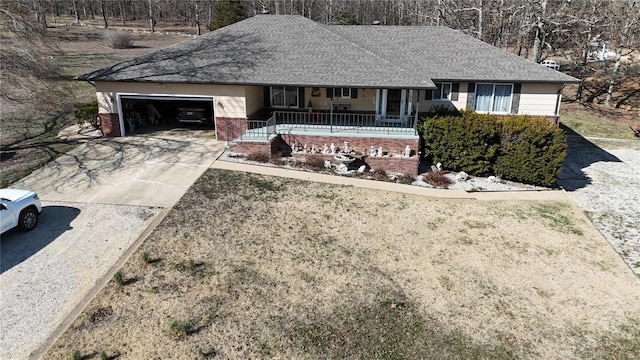 ranch-style house with brick siding, roof with shingles, covered porch, a garage, and driveway