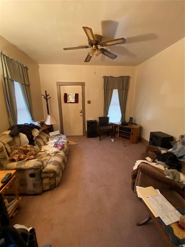 living room with ceiling fan and carpet