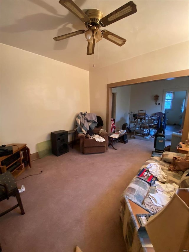 living room with ceiling fan and carpet flooring