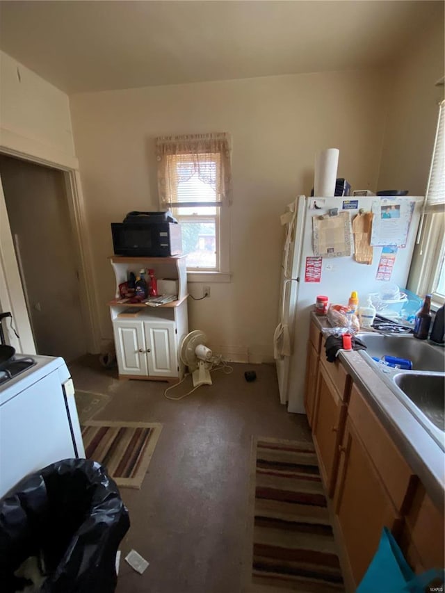 kitchen with sink, light carpet, and white fridge