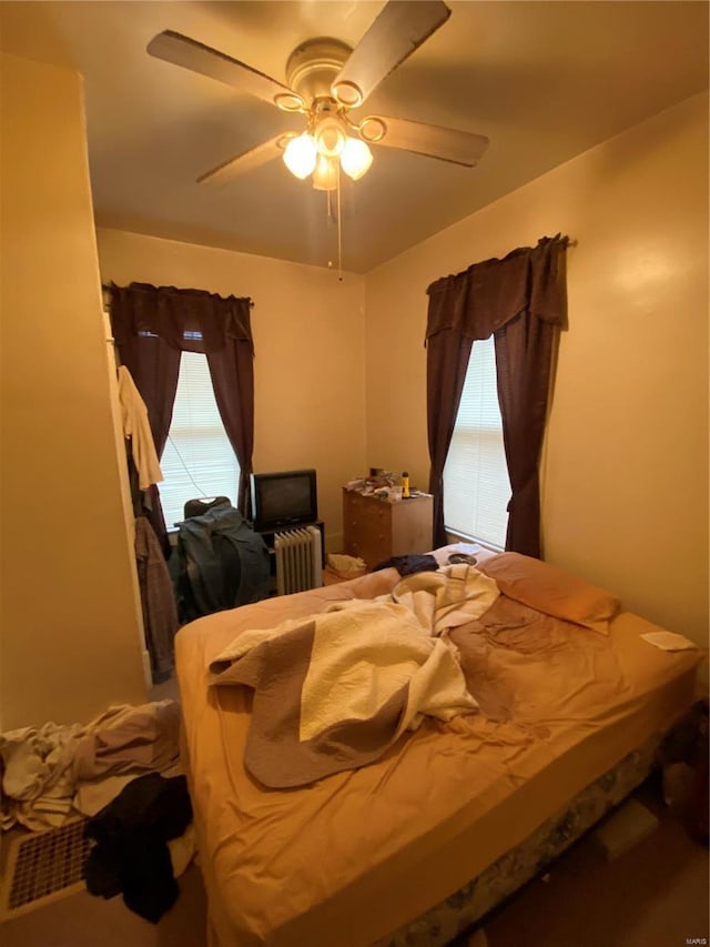 bedroom featuring radiator and ceiling fan