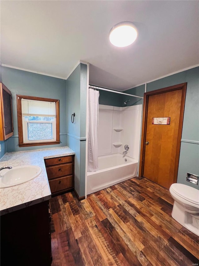 full bathroom featuring vanity, hardwood / wood-style floors, toilet, and shower / bath combo with shower curtain