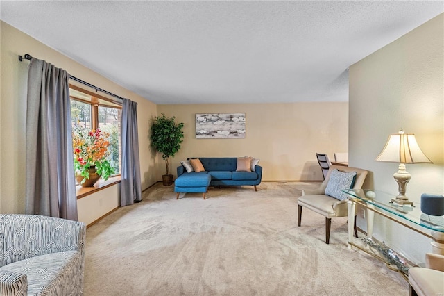 living area with light carpet and a textured ceiling