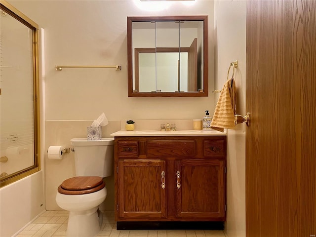 full bathroom featuring vanity, toilet, and enclosed tub / shower combo