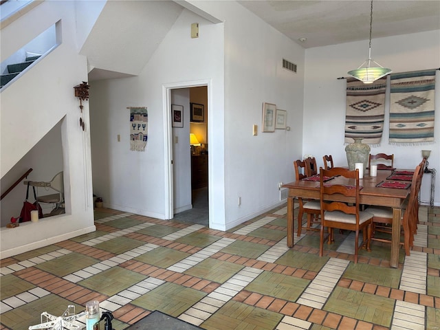 dining space with a towering ceiling