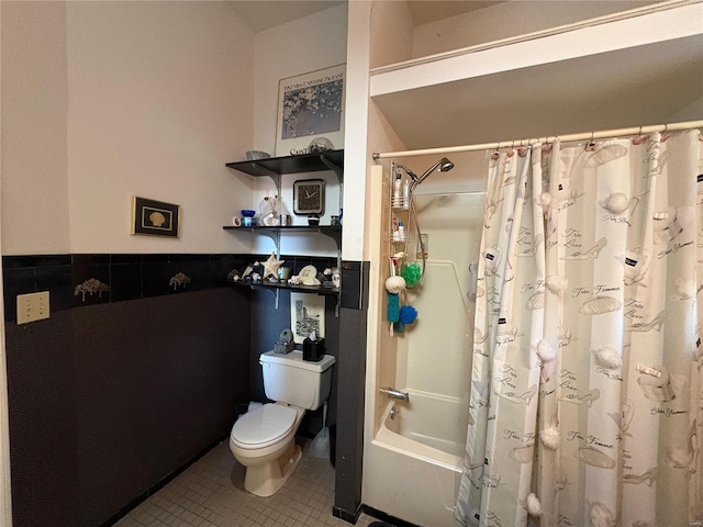 bathroom featuring shower / tub combo with curtain, tile patterned floors, and toilet