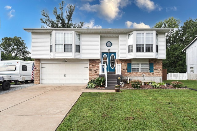 bi-level home featuring a garage and a front yard