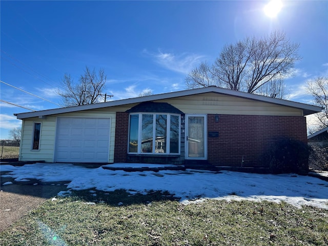 view of front of home with entry steps, an attached garage, and brick siding