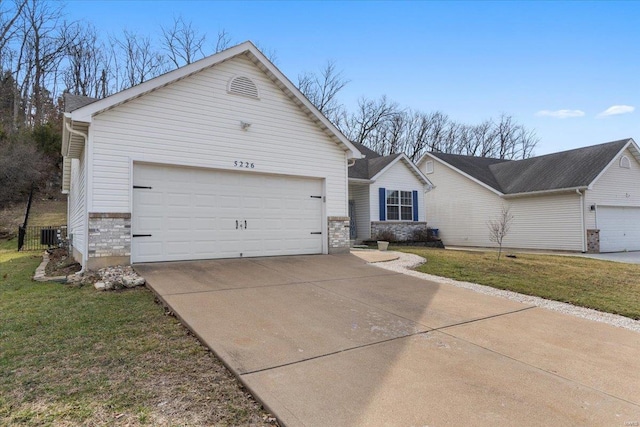 ranch-style house with a garage, driveway, and a front yard