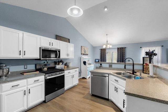 kitchen featuring stainless steel appliances, white cabinets, and a sink