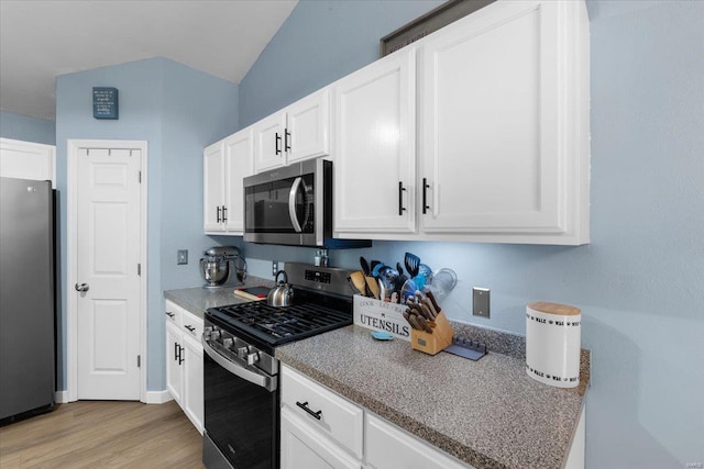 kitchen featuring appliances with stainless steel finishes, baseboards, white cabinetry, and light wood finished floors